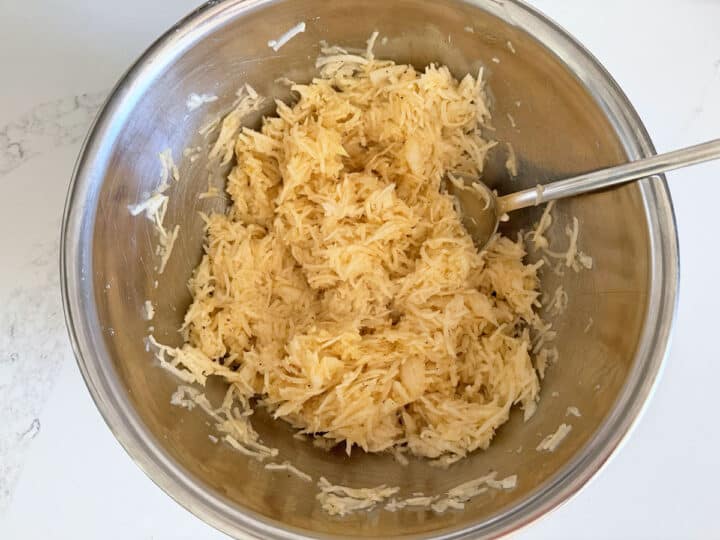 Mixing the eggs into the potatoes.