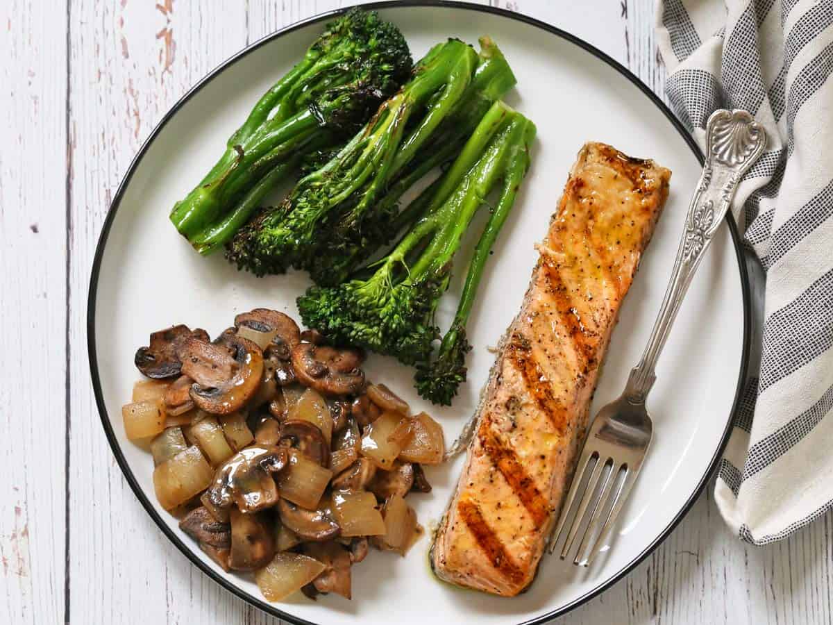 Omelette mushroom filling is served with grilled salmon and broccolini.