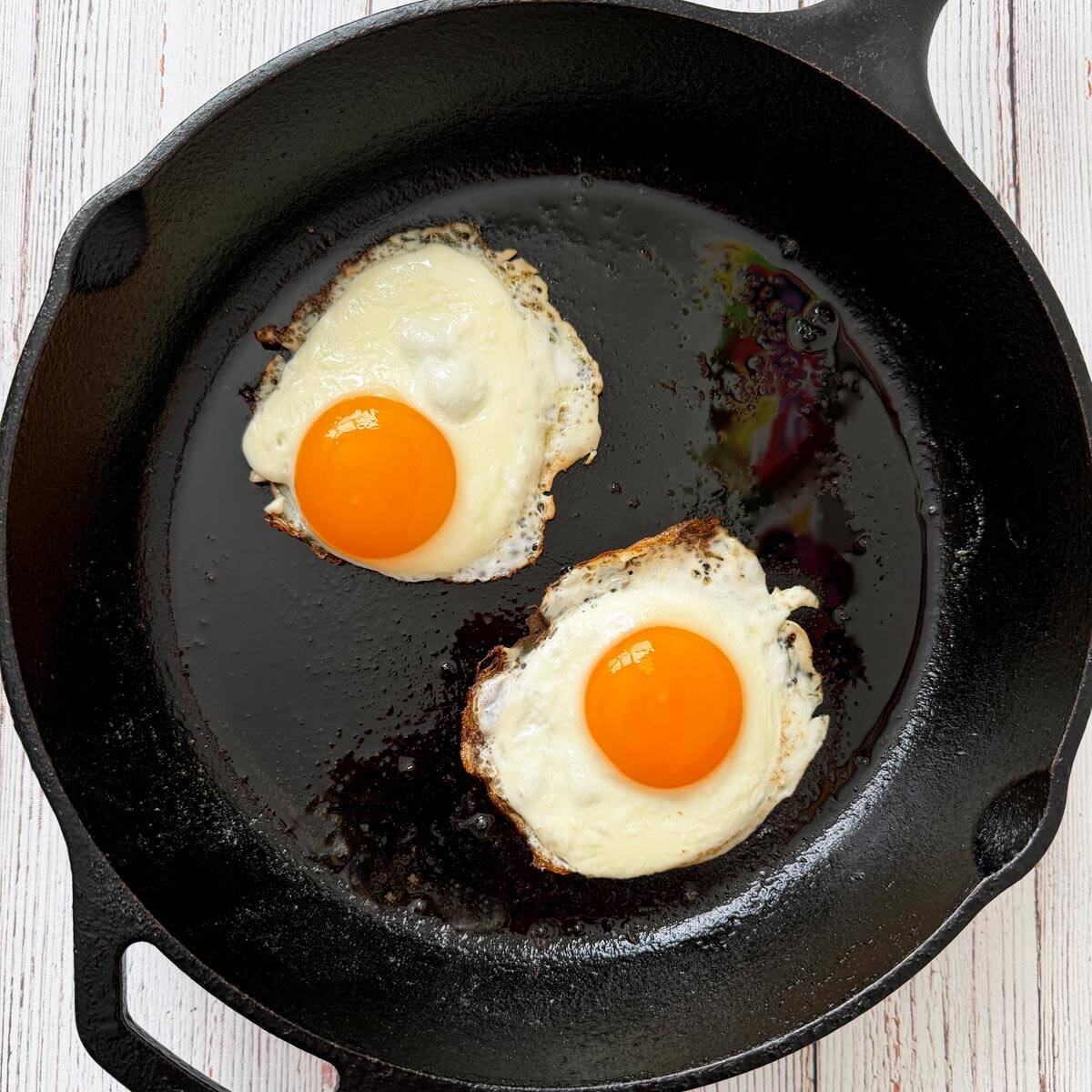 Two sunny side up eggs in a skillet.