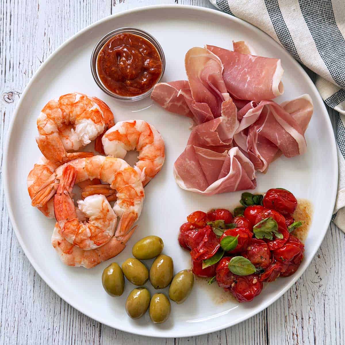 Cocktail sauce is served as a part of an appetizer plate.