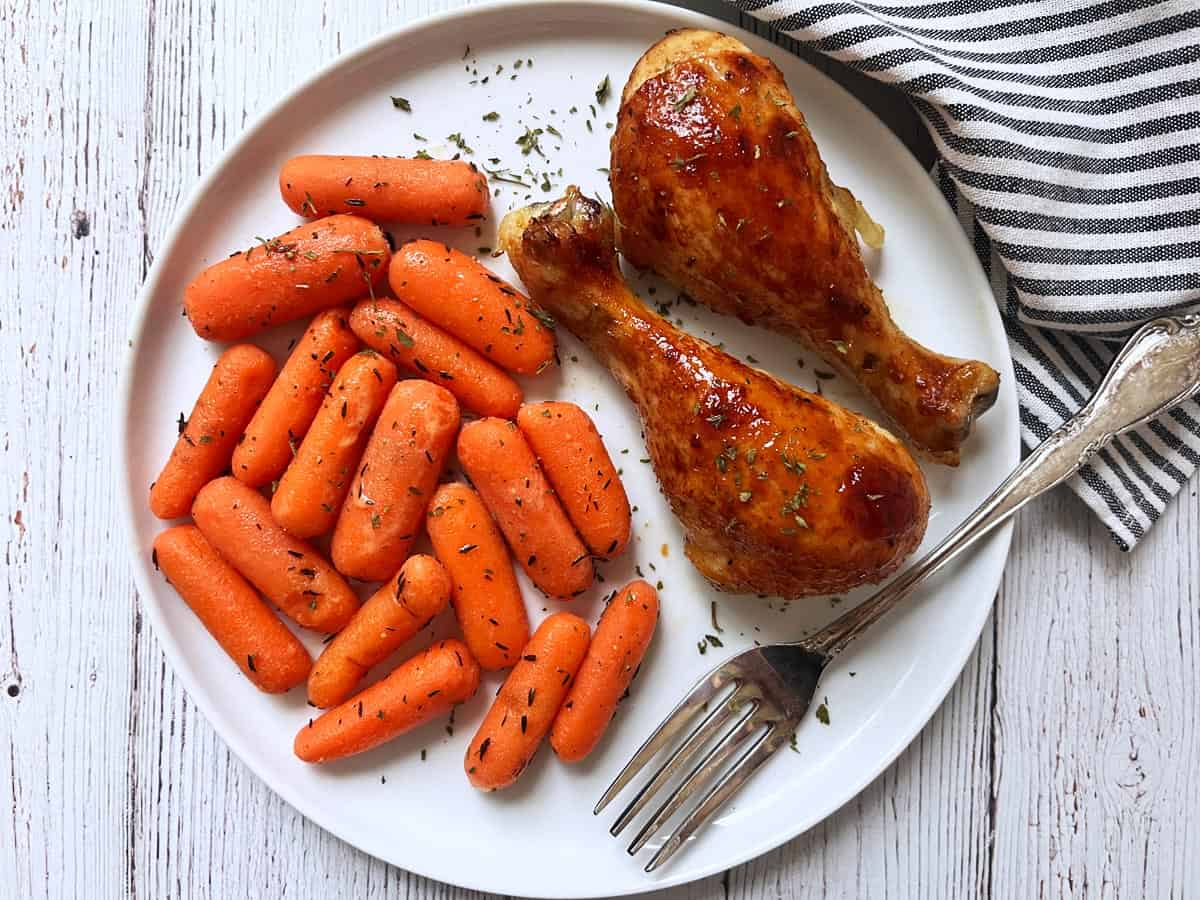 Honey garlic chicken is served with carrots.