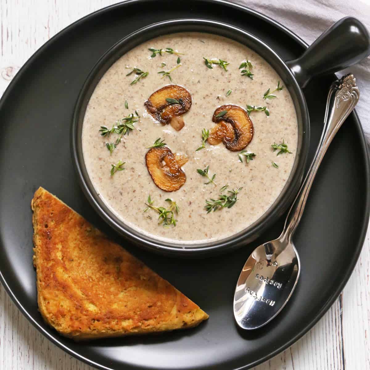 Mushroom soup is served with toast.