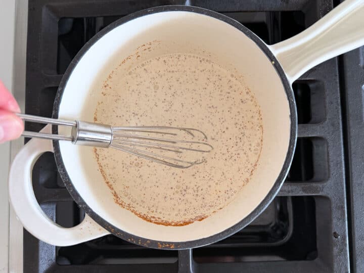 Whisking the heavy cream with Dijon and spices.